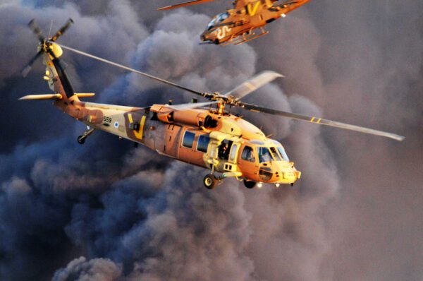 AN IAF UH-60 Black Hawk "Yanshuf" (owl) passing by an AH-1 Cobra "Tzefa" (Viper)